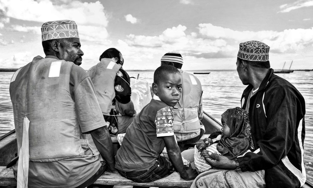 Black and white photo of people on a boat in Zanzibar, Tanzania.