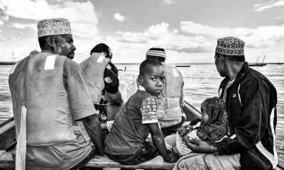 Black and white photo of people on a boat in Zanzibar, Tanzania.