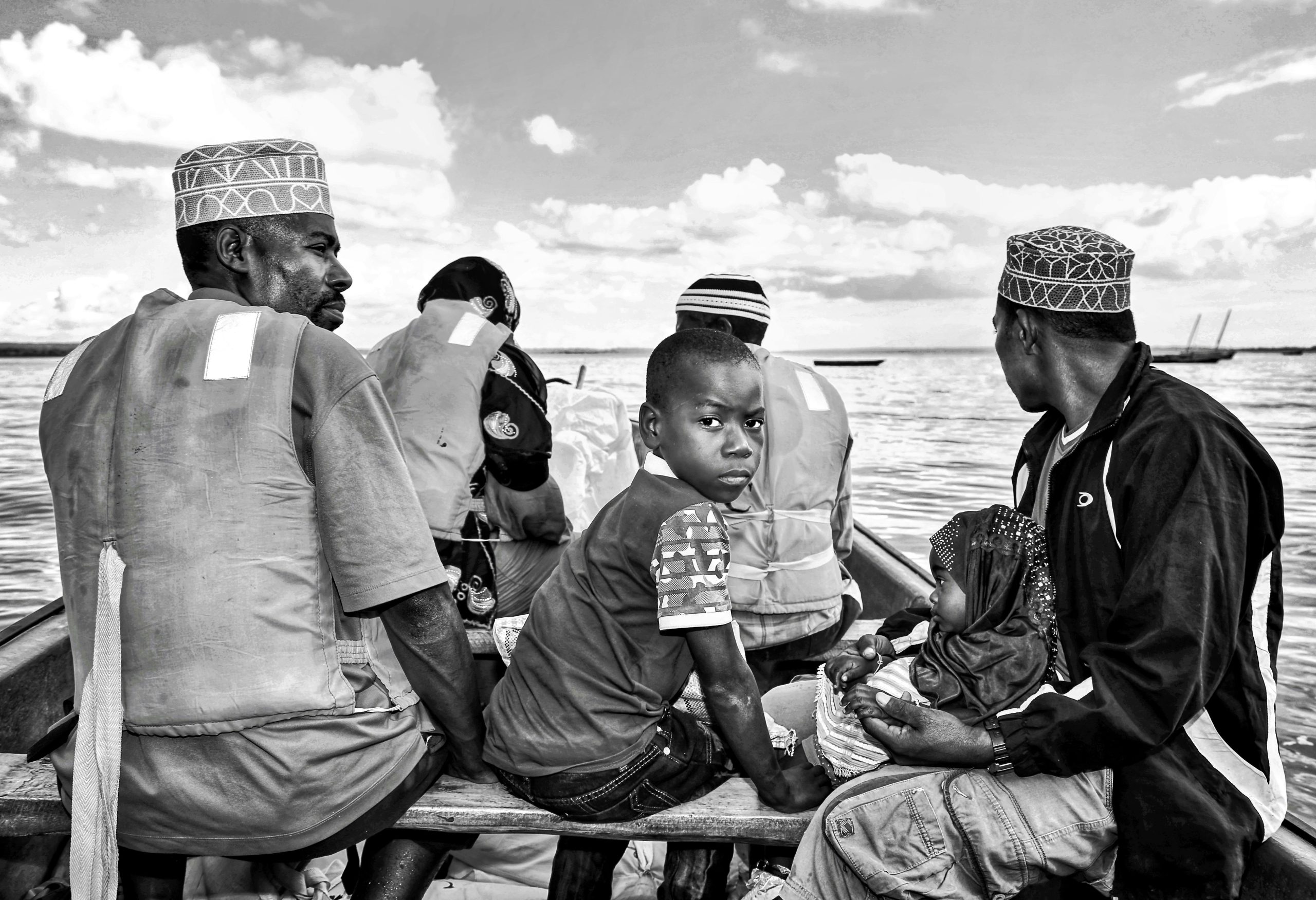 Black and white photo of people on a boat in Zanzibar, Tanzania.