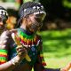 Two women in traditional attire perform a vibrant dance outdoors in The Gambia.