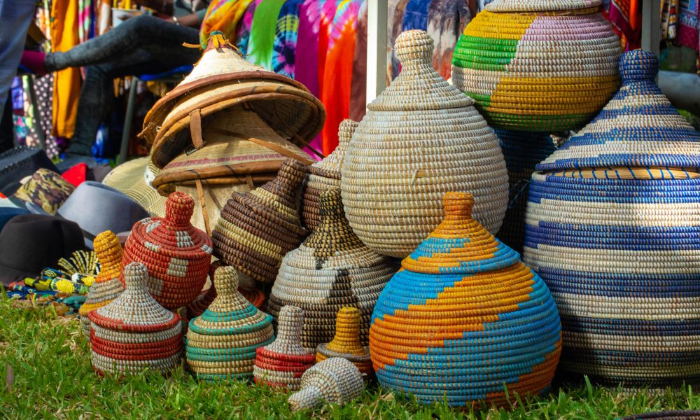 Brightly colored woven baskets displayed at a lively market in The Gambia.