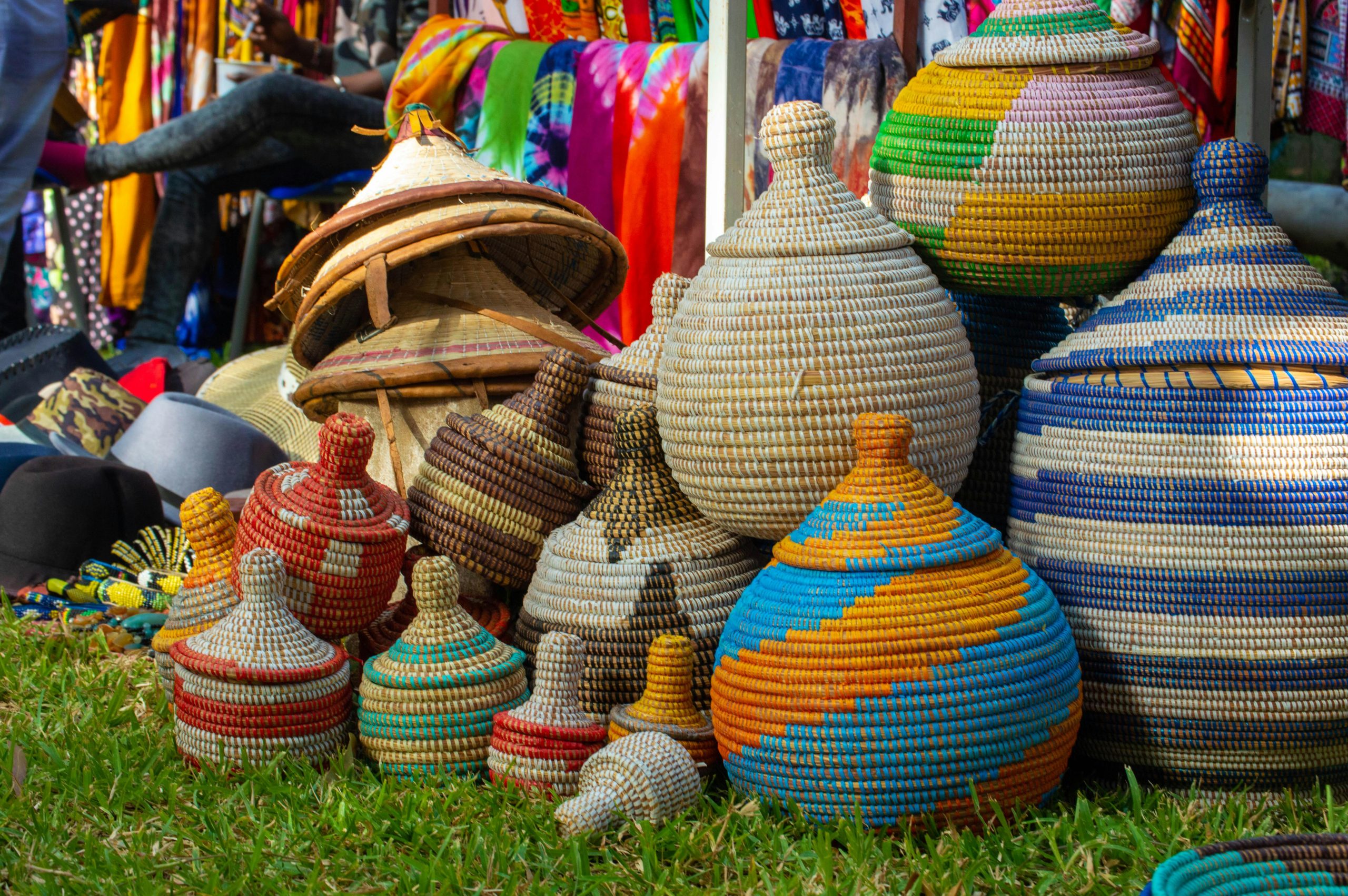 Brightly colored woven baskets displayed at a lively market in The Gambia.