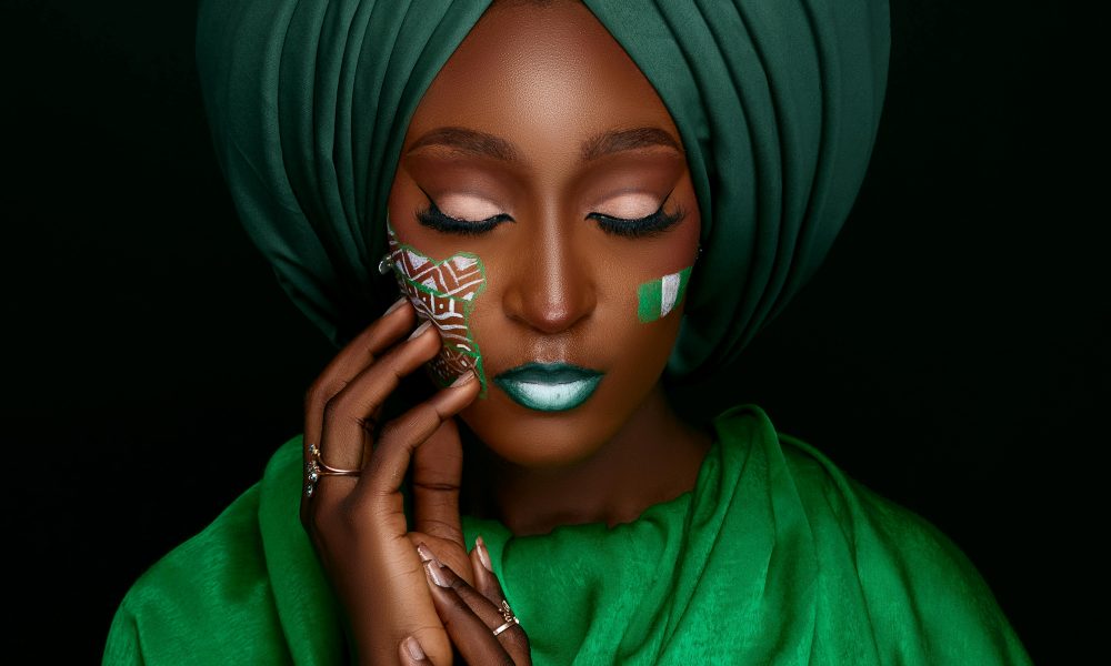 Portrait of a woman in a green turban with face paint, embodying cultural elegance.