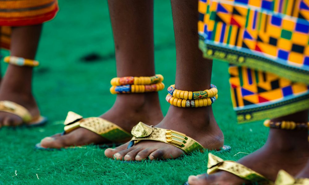 Close-up of traditional African attire and jewelry worn during a cultural festival in Accra, Ghana.
