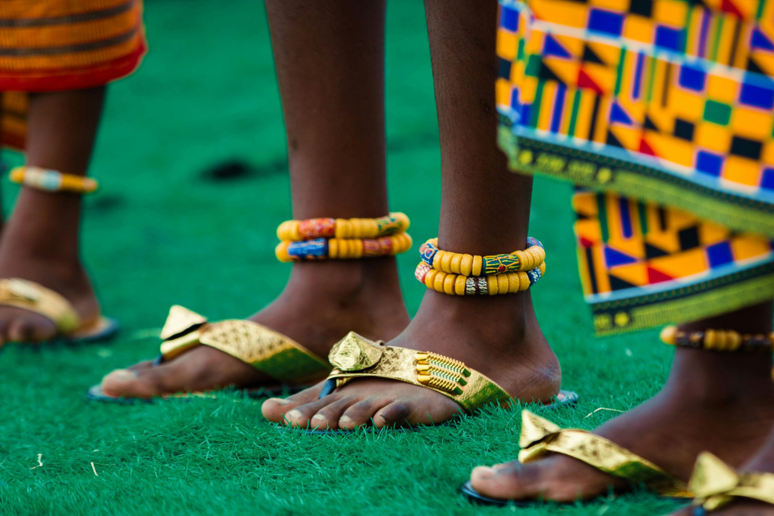 Close-up of traditional African attire and jewelry worn during a cultural festival in Accra, Ghana.